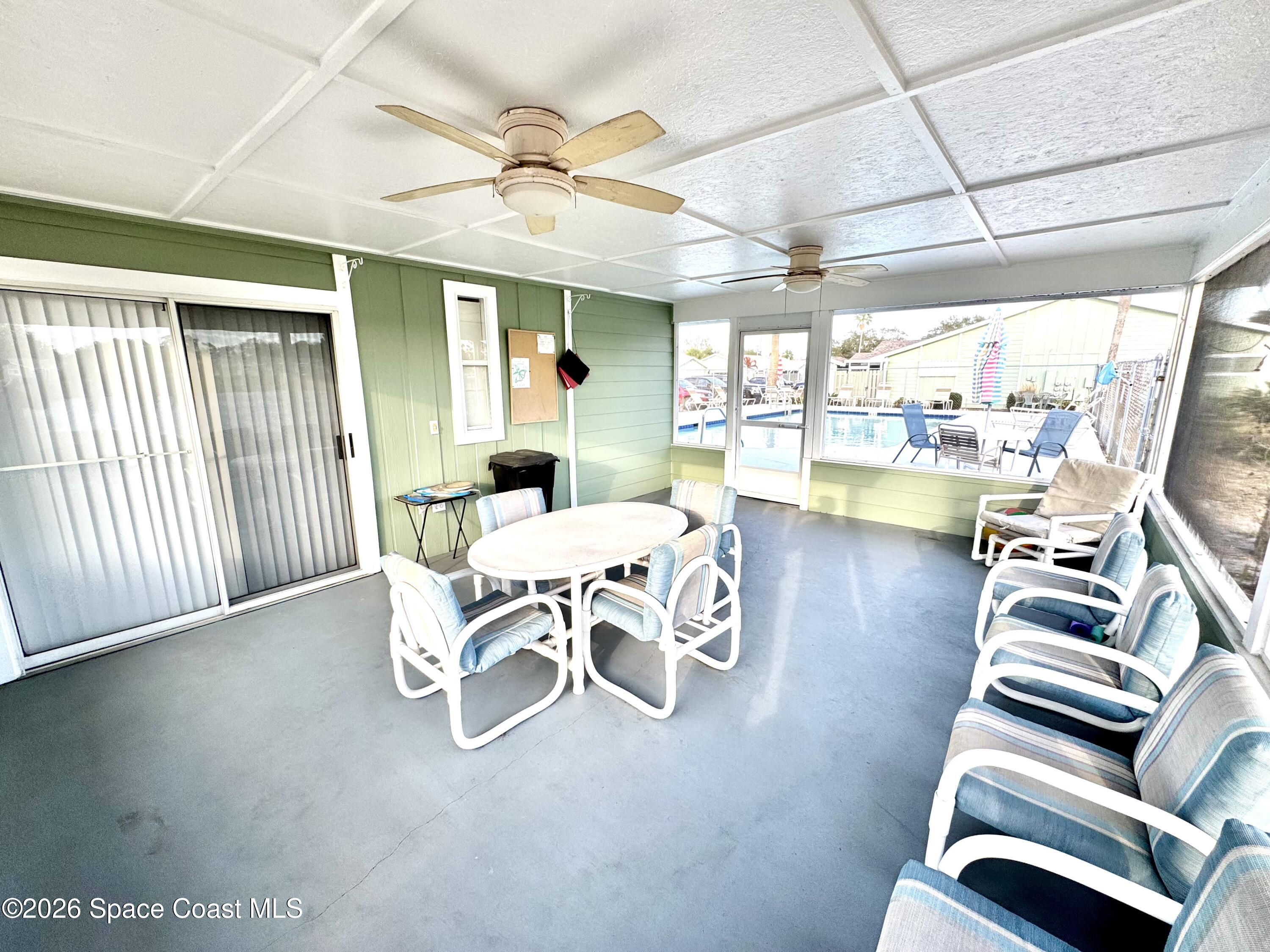 1942 Quail Ridge Court, Unit 504 Cocoa, FL 32926 - Photo 25 of 27 a dining room with furniture a chandelier and wooden floor