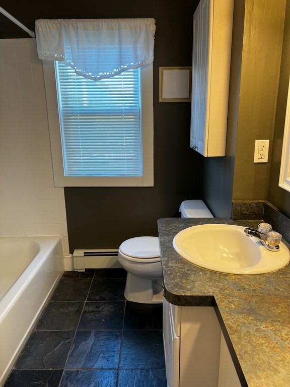 196 Boston Road Chelmsford, MA 01824 - Photo 13 of 26 a bathroom with a sink a toilet and a bathtub