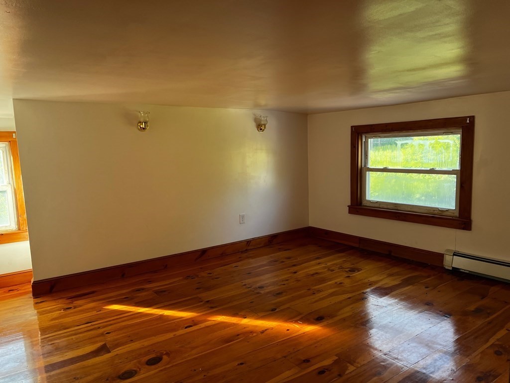 196 Boston Road Chelmsford, MA 01824 - Photo 21 of 26 a view of an empty room with wooden floor and a window