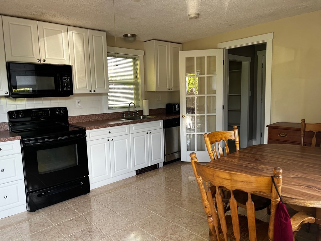 196 Boston Road Chelmsford, MA 01824 - Photo 3 of 26 a kitchen with stainless steel appliances a stove a sink and a microwave