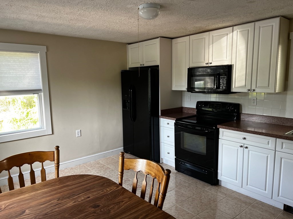 196 Boston Road Chelmsford, MA 01824 - Photo 4 of 26 a kitchen with stainless steel appliances granite countertop a refrigerator stove microwave and sink