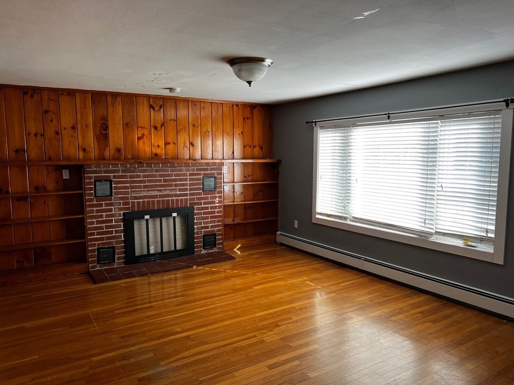 196 Boston Road Chelmsford, MA 01824 - Photo 9 of 26 a view of an empty room with a fireplace and a window