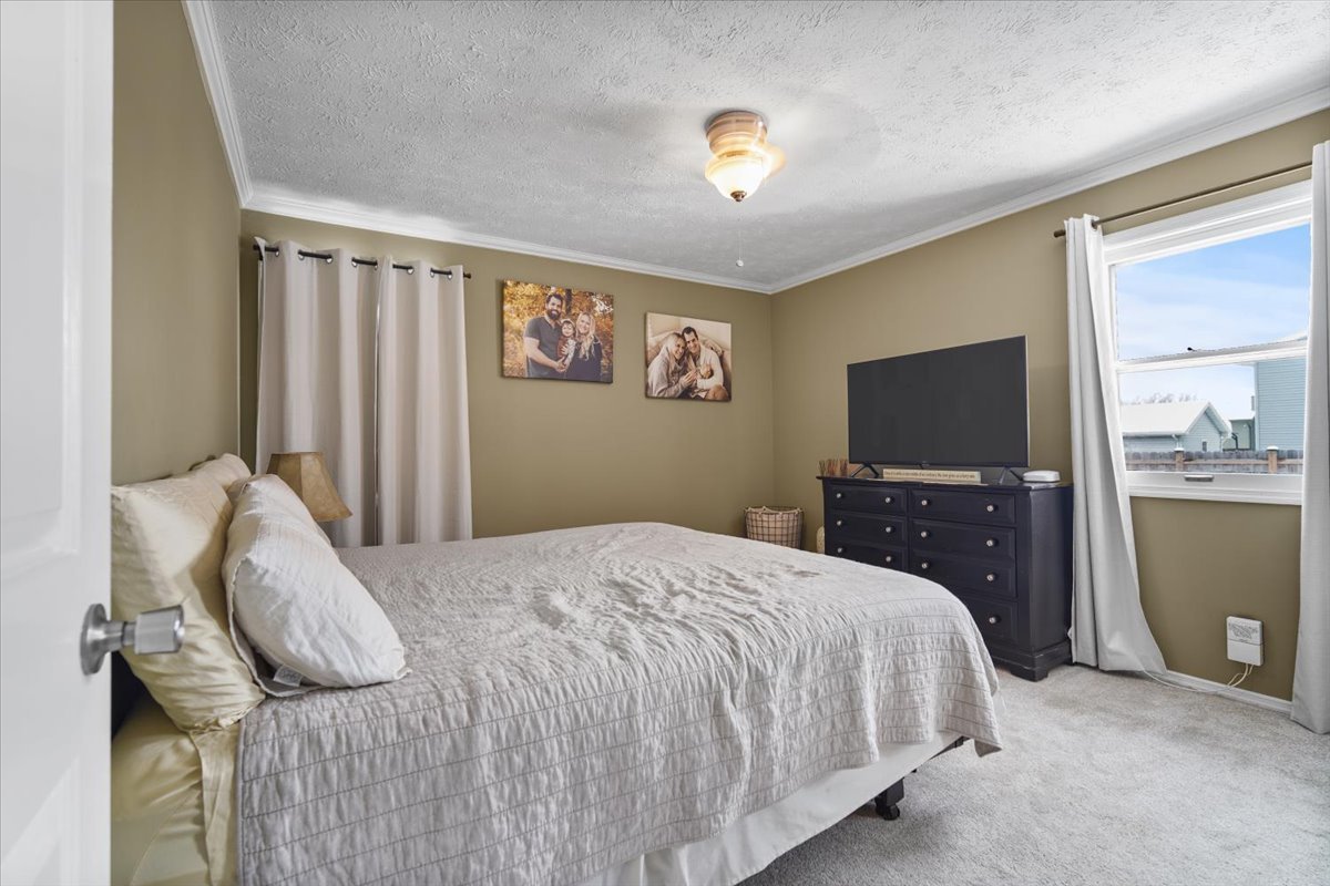 2 Yew Court Bloomington, IL 61701 - Photo 11 of 27 a bedroom with a bed and a flat screen tv