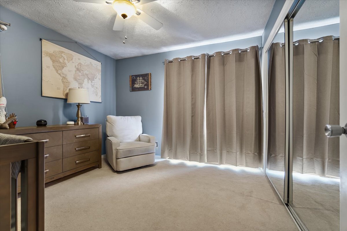 2 Yew Court Bloomington, IL 61701 - Photo 14 of 27 a spacious bedroom with a bed and a chandelier