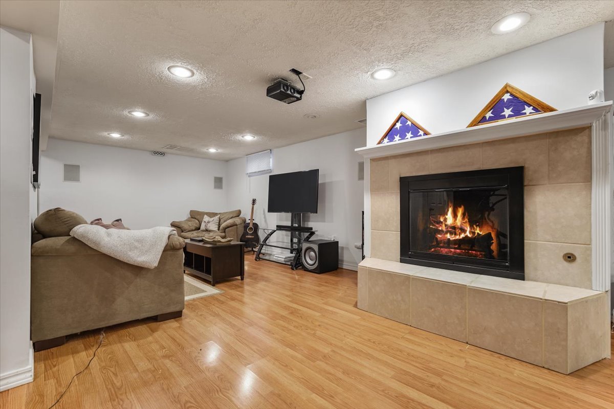 2 Yew Court Bloomington, IL 61701 - Photo 20 of 27 a living room with furniture a fireplace and a flat screen tv