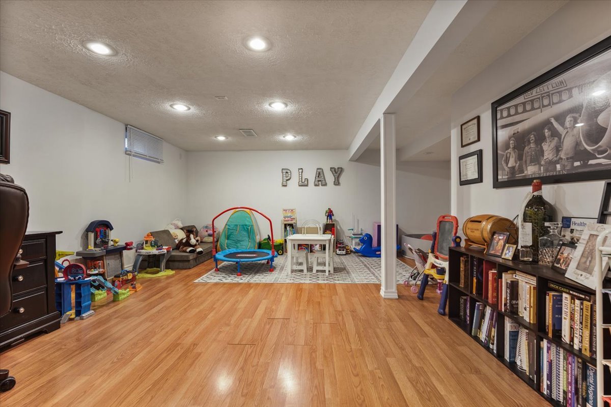 2 Yew Court Bloomington, IL 61701 - Photo 21 of 27 a living room with lots of furniture and gym equipment