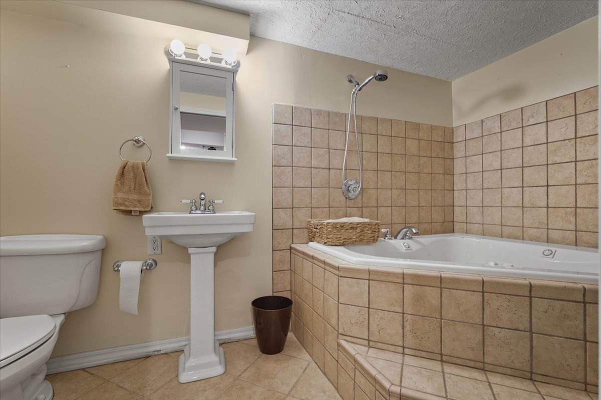 2 Yew Court Bloomington, IL 61701 - Photo 23 of 27 a bathroom with a sink toilet and shower