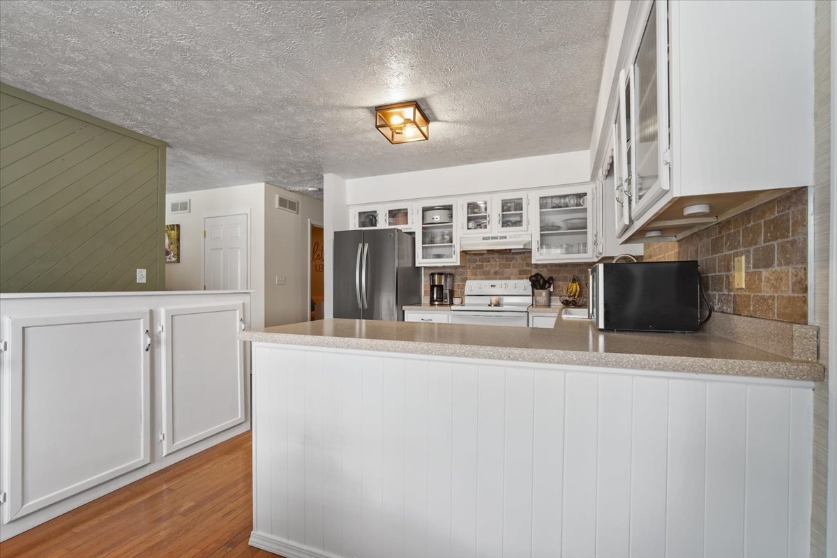 2 Yew Court Bloomington, IL 61701 - Photo 6 of 27 a kitchen with a refrigerator and a stove top oven