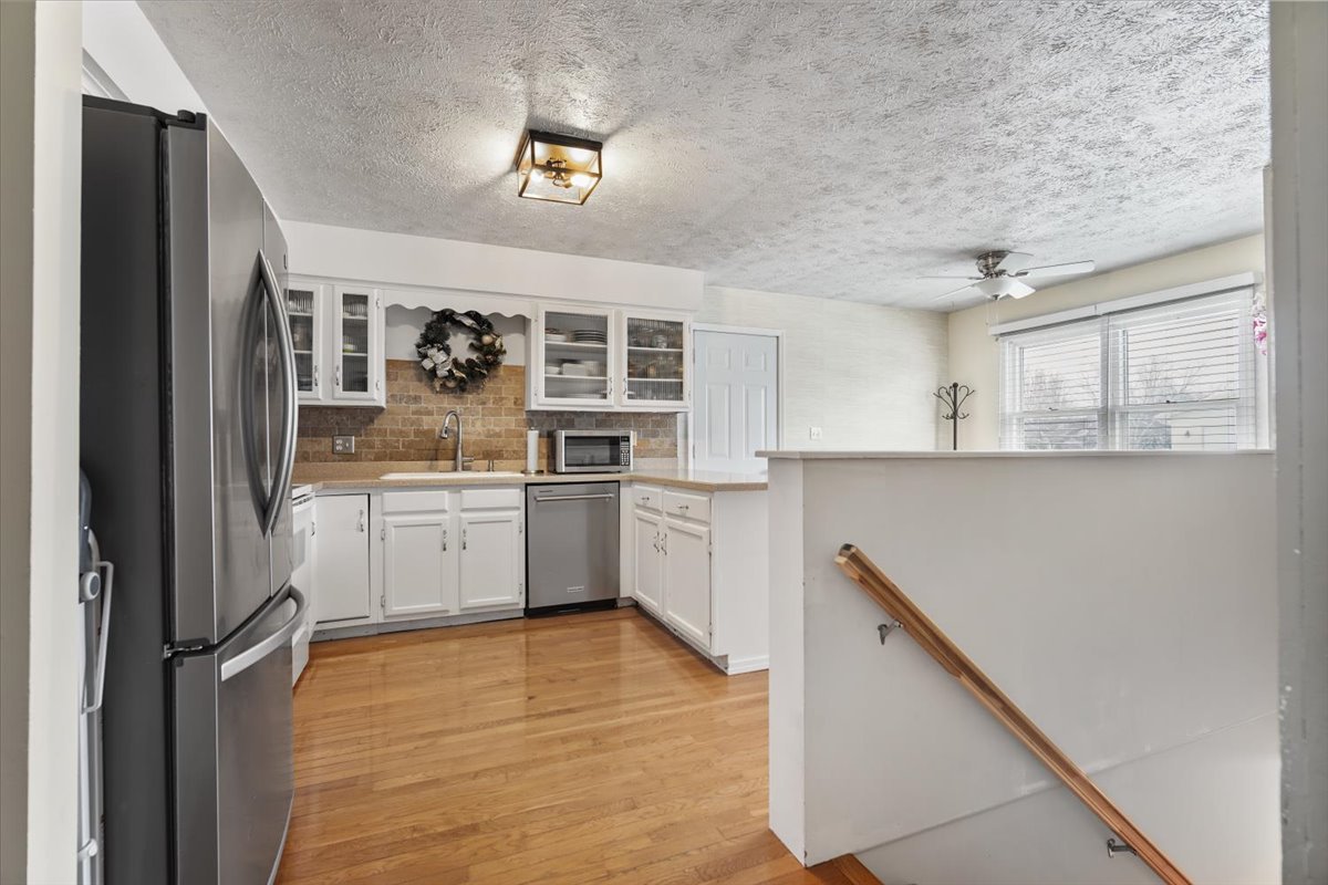 2 Yew Court Bloomington, IL 61701 - Photo 7 of 27 a kitchen with a sink window and stainless steel appliances