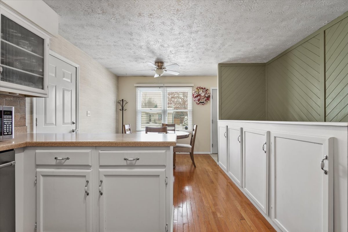 2 Yew Court Bloomington, IL 61701 - Photo 9 of 27 a kitchen with cabinets and wooden floor