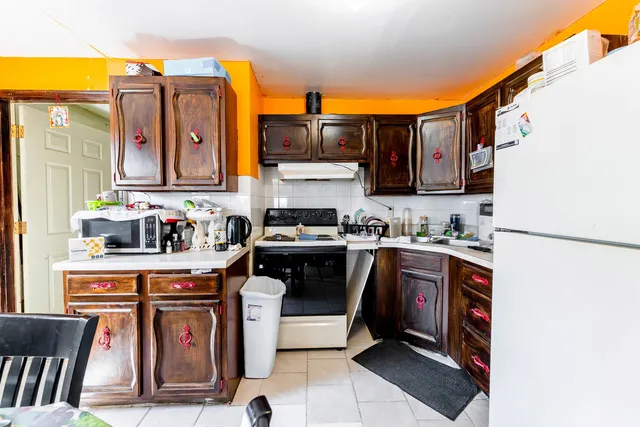 a kitchen with stainless steel appliances granite countertop a stove a sink and a refrigerator