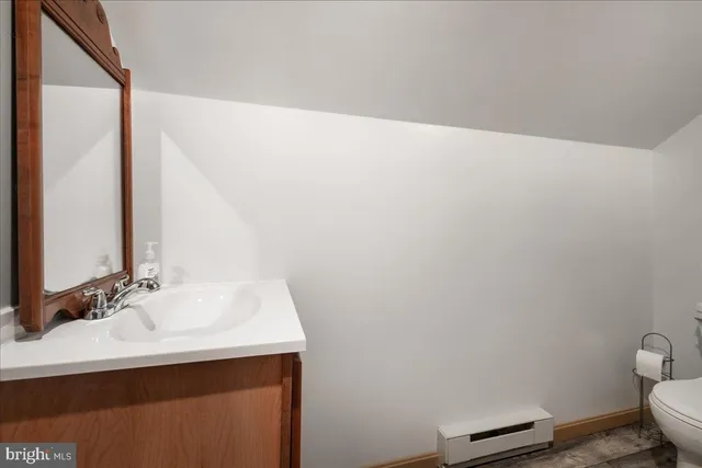 a white toilet sitting next to a shower curtain