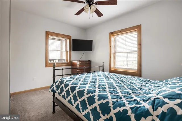 a bedroom with a bed and window