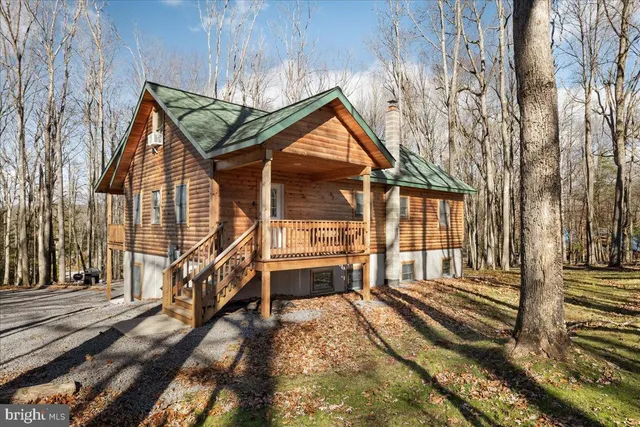 a view of a house with a small yard and wooden fence