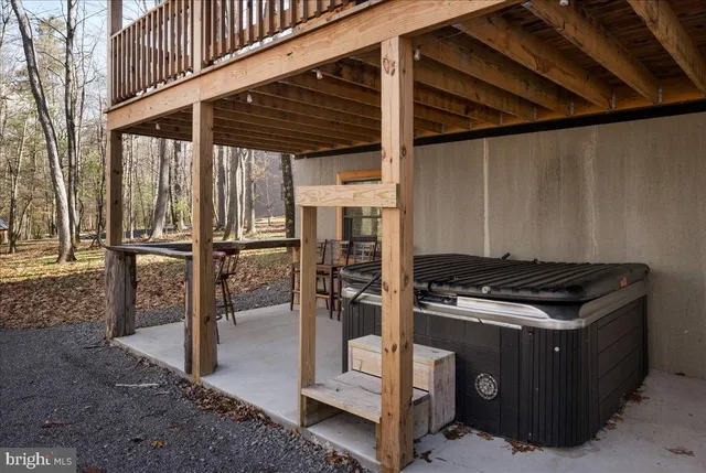 a view of swimming pool with lawn chairs and couches