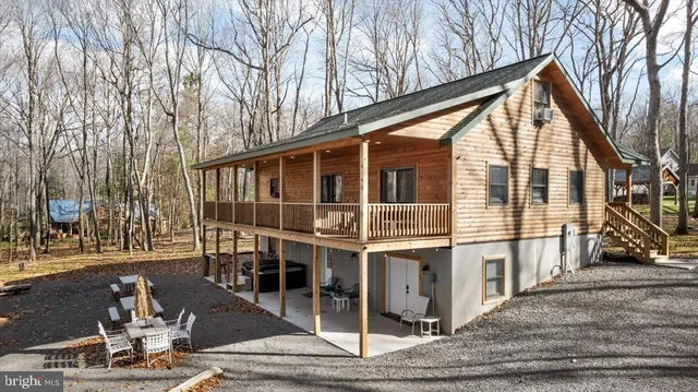a view of house with yard and sitting area