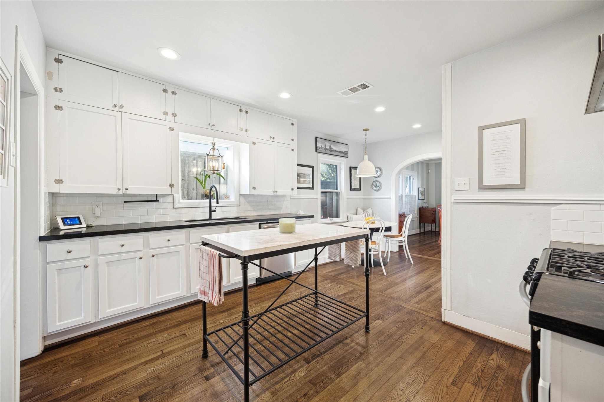 2109 Colquitt Street Houston, TX 77098 - Photo 14 of 28 a kitchen with stainless steel appliances granite countertop a stove top oven a sink dishwasher and cabinets with wooden floor
