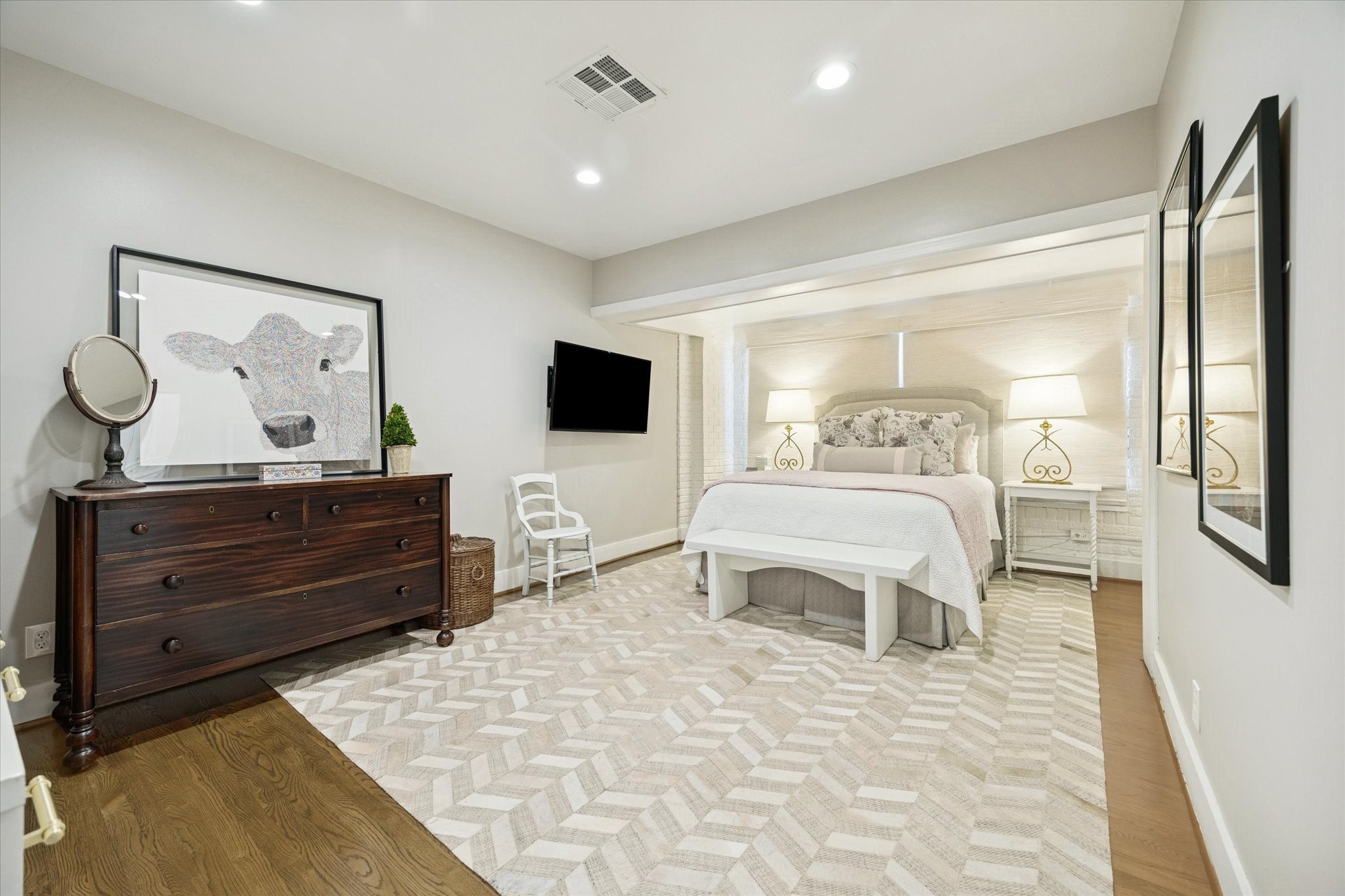 2109 Colquitt Street Houston, TX 77098 - Photo 16 of 28 The spacious primary bedroom offers recessed lighting, soft neutral tones, and a serene layout designed for comfort and relaxation.