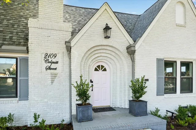 a view of a house with potted plants