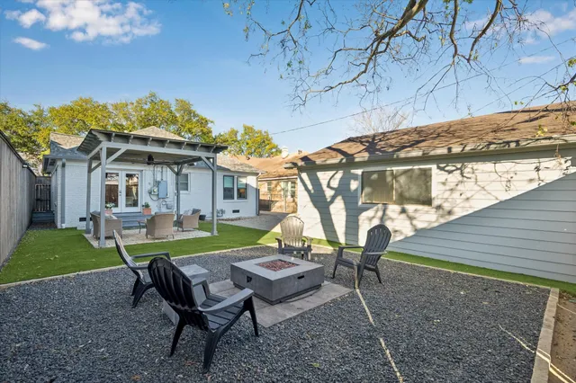 a view of a house with backyard and sitting area