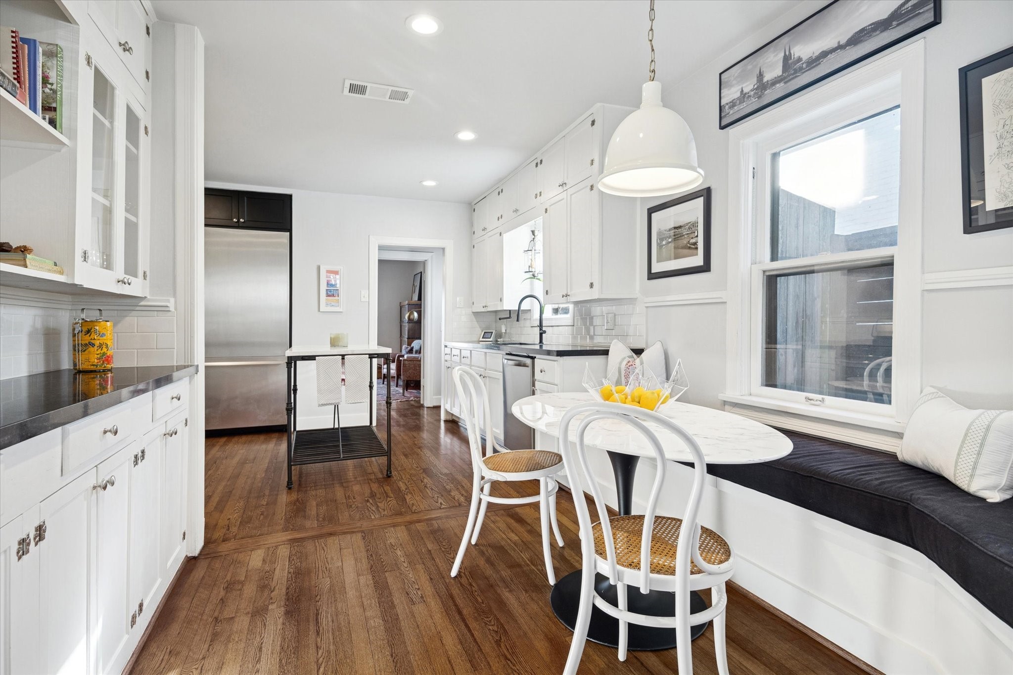 2109 Colquitt Street Houston, TX 77098 - Photo 10 of 28 a view of a dining room with furniture a chandelier and wooden floor