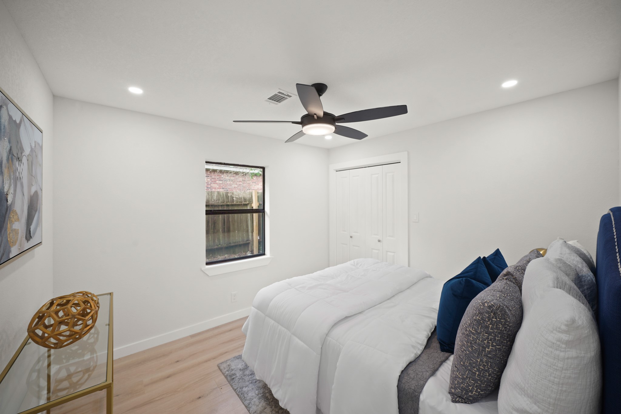4813 Hummingbird Street Houston, TX 77035 - Photo 20 of 50 The Third Bedroom features Side by Side Picture Sized Windows that view the Side Yard and a Wardrobe Closet with Built in Shelf, Hanging Rods, and 2 Panel Double Door Enclosure.