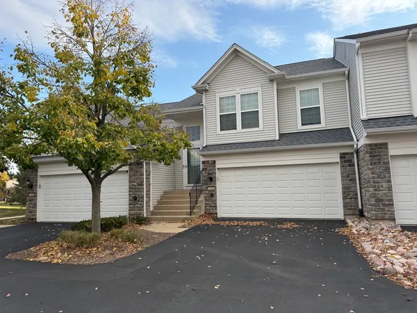 a front view of a house with a garage