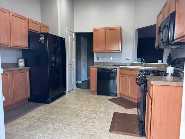 a kitchen with stainless steel appliances granite countertop a refrigerator and a stove top oven