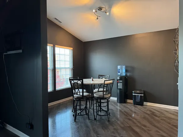 a view of a dining room with furniture and wooden floor