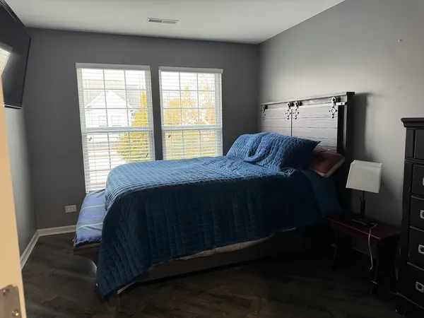 a bedroom with a bed and window