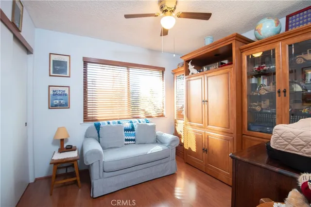 a bedroom with a bed dresser and a window