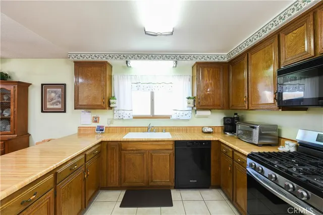 a kitchen with a sink stove top oven and cabinets