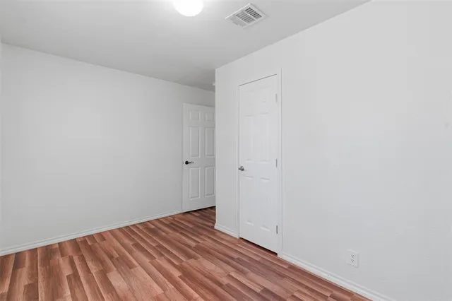 a view of room with wooden floor