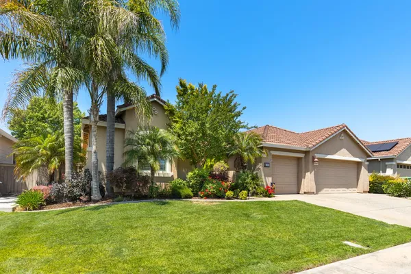 a front view of house with yard and green space