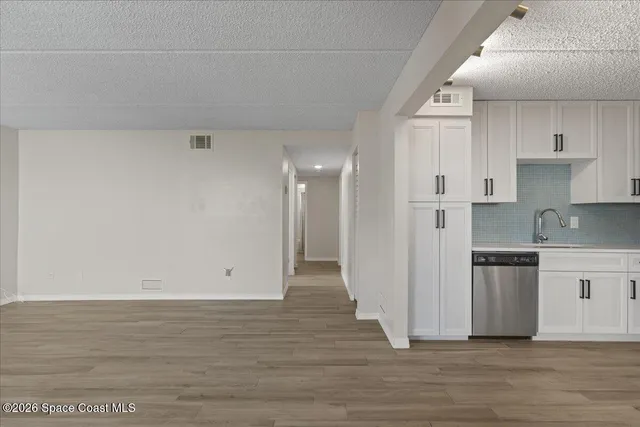 a view of kitchen with granite countertop cabinets and wooden floor