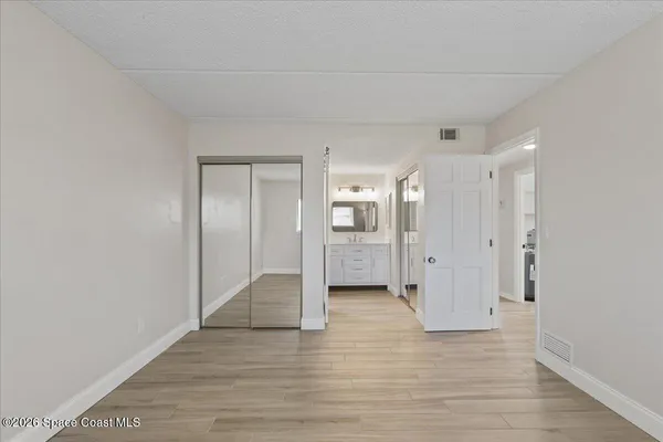 a view of a hallway with wooden floor