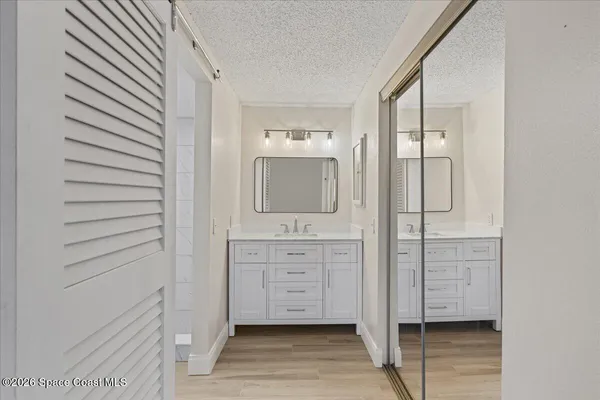 a bathroom with a double vanity sink and mirror