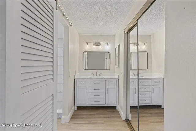 a bathroom with a double vanity sink and mirror