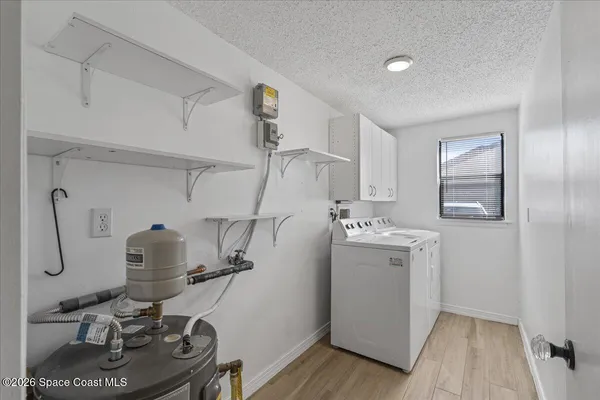 a view of a workspace with furniture and washer
