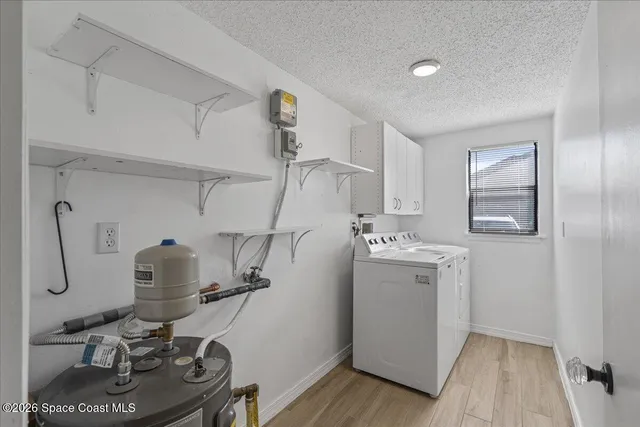 a view of a workspace with furniture and washer