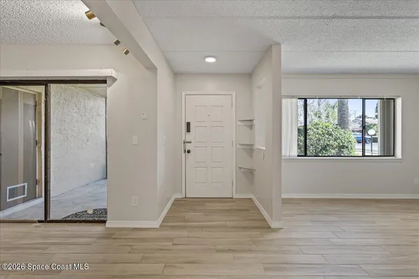 a view of entryway with wooden floor