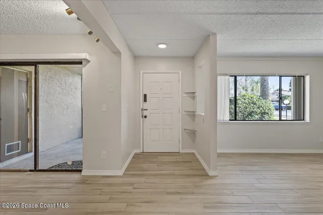 a view of entryway with wooden floor