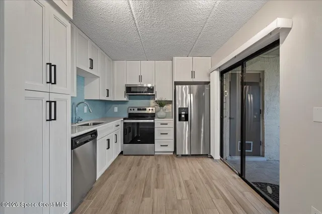 a kitchen with stainless steel appliances a refrigerator stove and sink