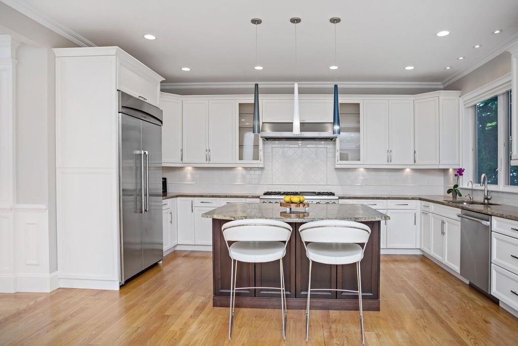 34 Dorothy Road Newton, MA 02459 - Photo 14 of 41 a kitchen with granite countertop white cabinets and stainless steel appliances