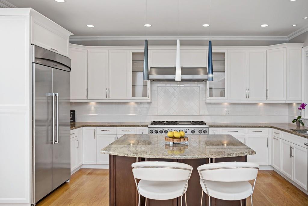 34 Dorothy Road Newton, MA 02459 - Photo 8 of 41 a kitchen with stainless steel appliances granite countertop a white cabinets and a refrigerator
