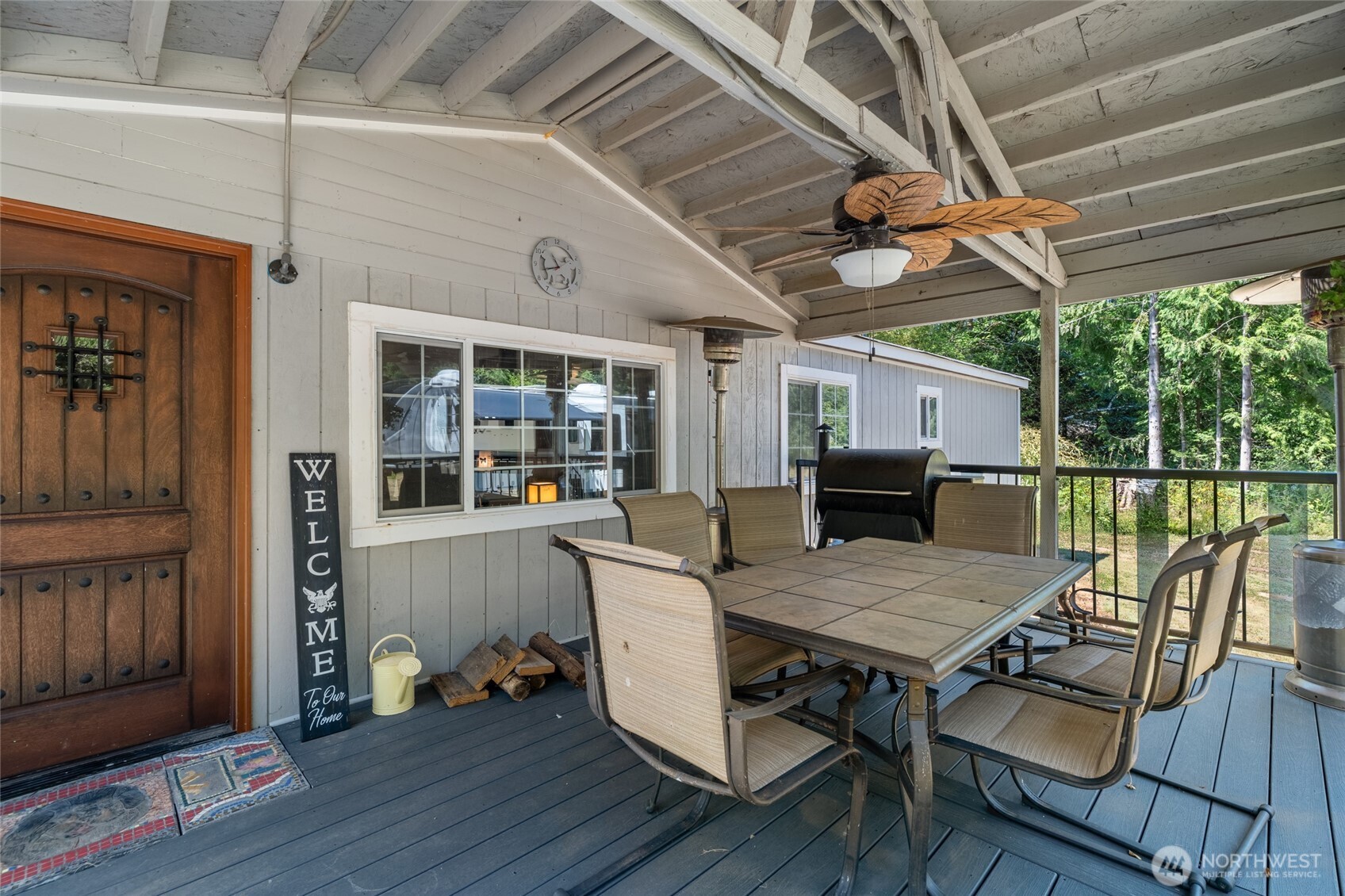 19619 Michigan Hill Road Southwest Rochester, WA 98579 - Photo 22 of 40 a view of a patio with table and chairs with wooden floor and fence