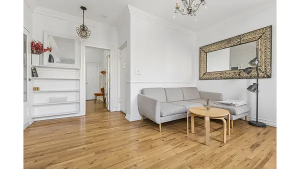 a living room with furniture and a chandelier