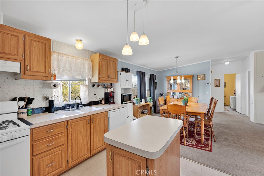 12837 Hacienda Road Phelan, CA 92371 - Photo 13 of 51 a large kitchen with a table and chairs