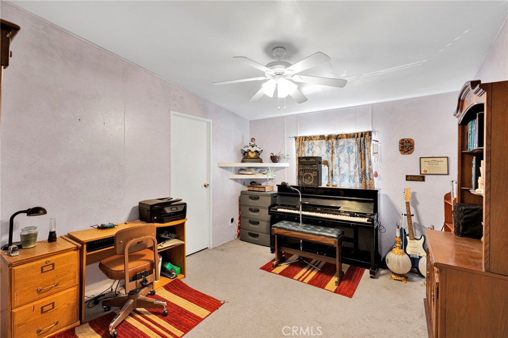 12837 Hacienda Road Phelan, CA 92371 - Photo 16 of 51 a room with furniture a flat screen tv and gym equipment