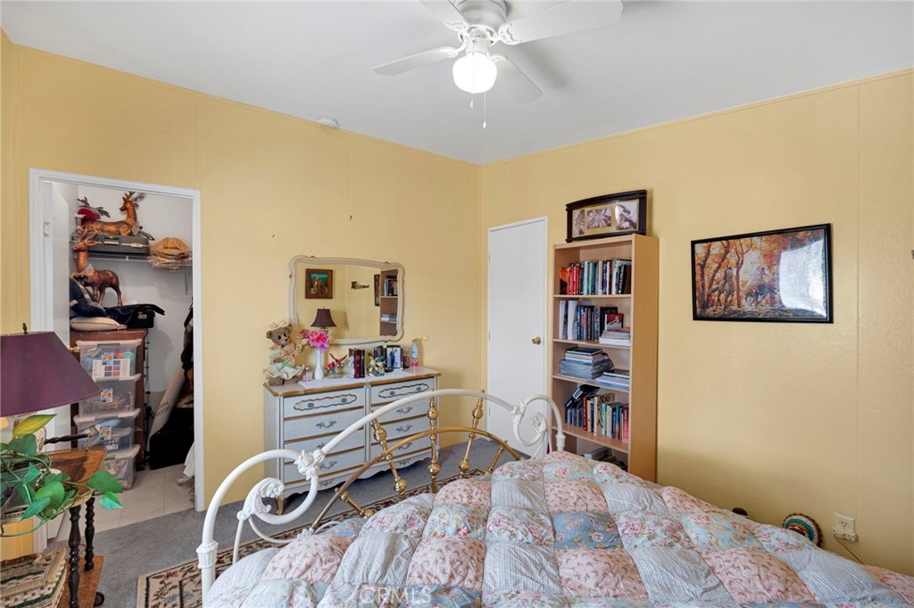 12837 Hacienda Road Phelan, CA 92371 - Photo 19 of 51 a bedroom with a bed and cabinets